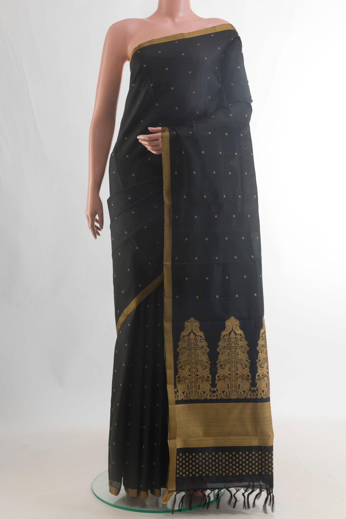 Pure Silk Black Kanchipuram Saree with Thread Butta on the body and Plain Border.  displayed on a mannequin