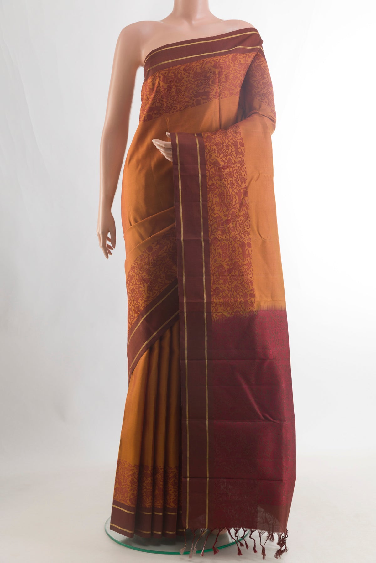 Pure Silk Rust Kanchipuram Saree with Plain Body and Thread Border.  displayed on a mannequin