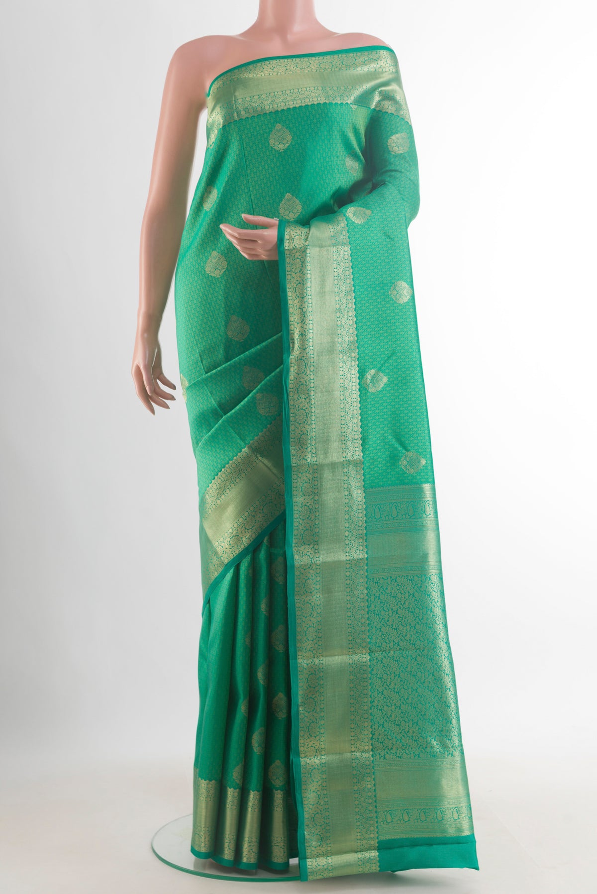 Pure Silk Green Kanchipuram Saree with Jacquard With Zari Butta on the body and Zari Border.  displayed on a mannequin