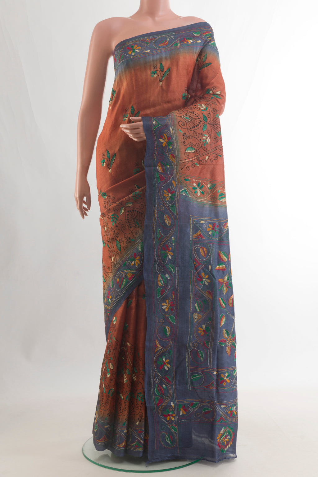 Rust Tussar Saree with Kantha Work on the body and Embroidery Border.  displayed on a mannequin