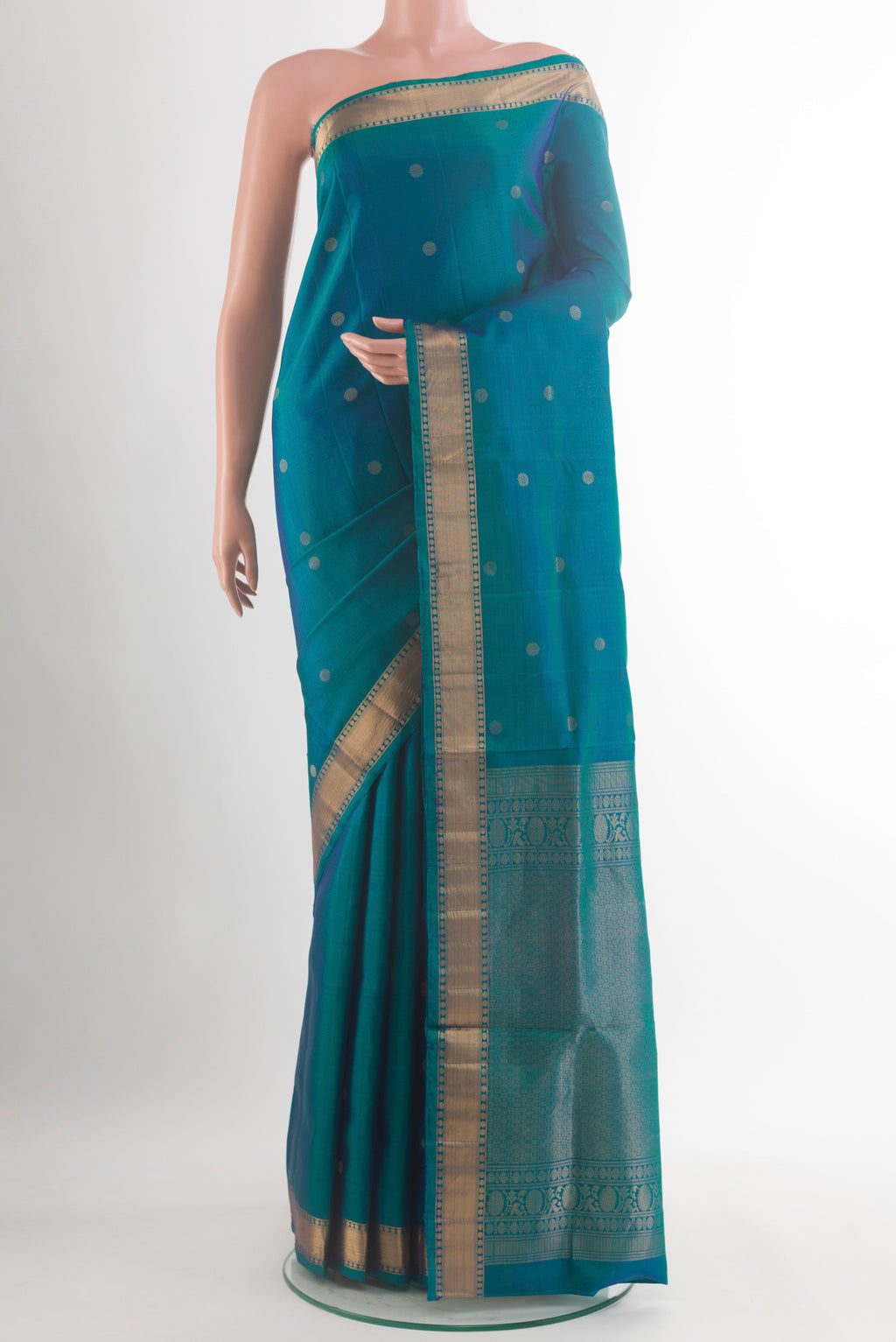 Pure Silk Peacock Blue Soft Saree with Zari Butta on the body and Zari Border.  displayed on a mannequin
