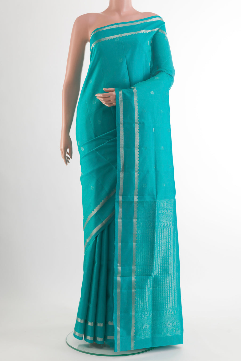 Pure Silk Turquoise Soft Saree with Zari Butta on the body and Zari Border.  displayed on a mannequin