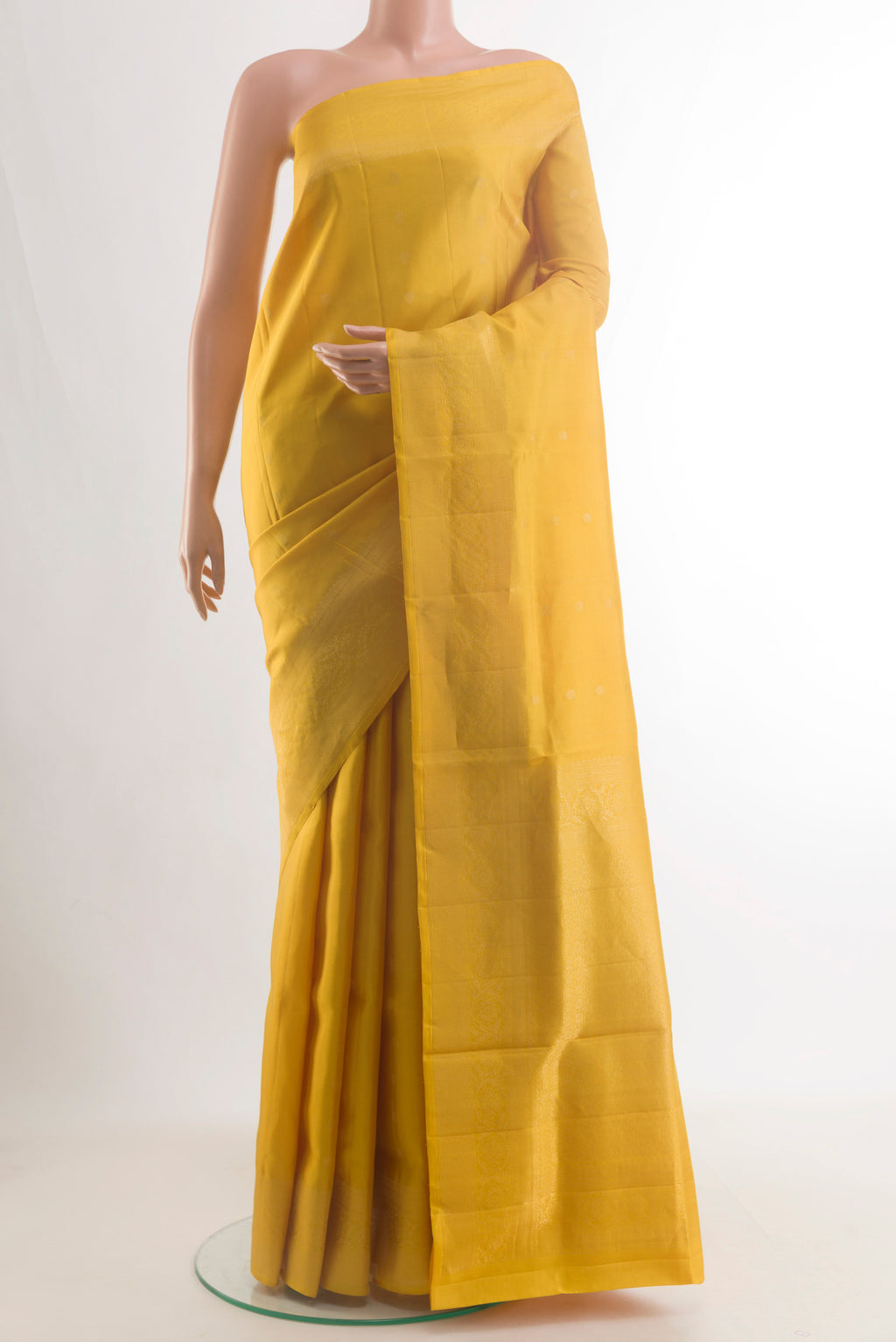Pure Silk Yellow Soft Saree with Zari Butta on the body and Zari Border.  displayed on a mannequin