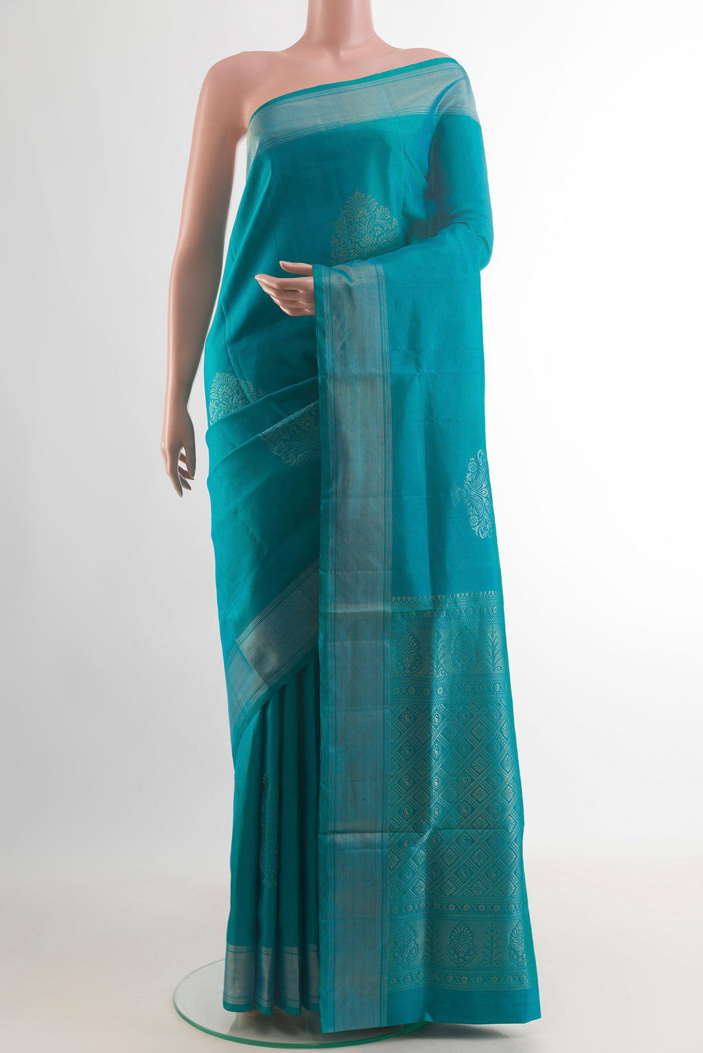 Pure Silk Turquoise Soft Saree with Zari Butta on the body and Zari Border.  displayed on a mannequin