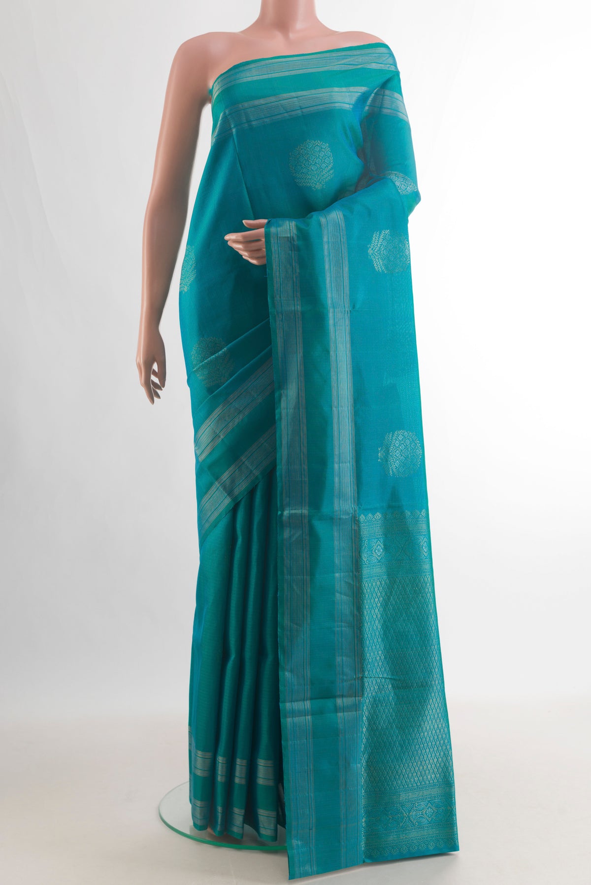 Pure Silk Turquoise Soft Saree with Zari Butta on the body and Zari Border.  displayed on a mannequin