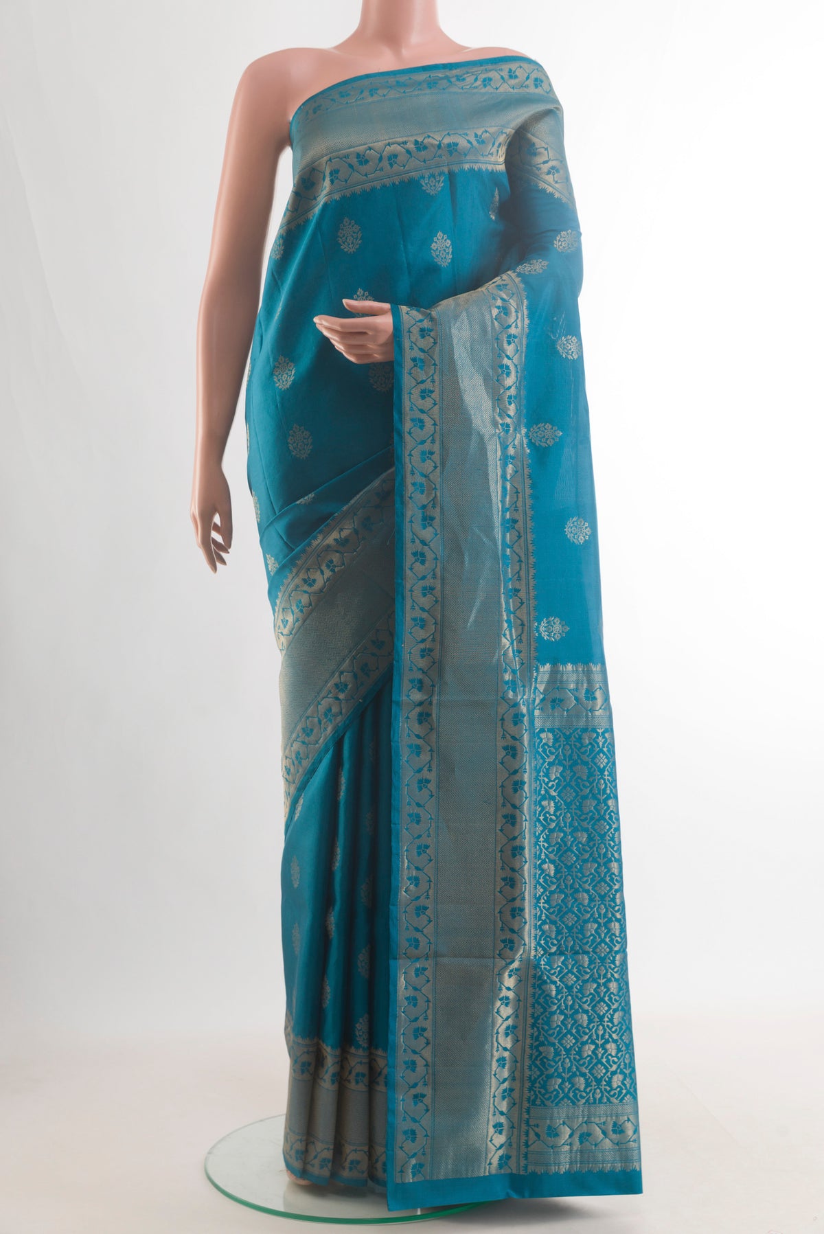 Pure Silk Blue Soft Saree with Zari Butta on the body and Zari Border.  displayed on a mannequin