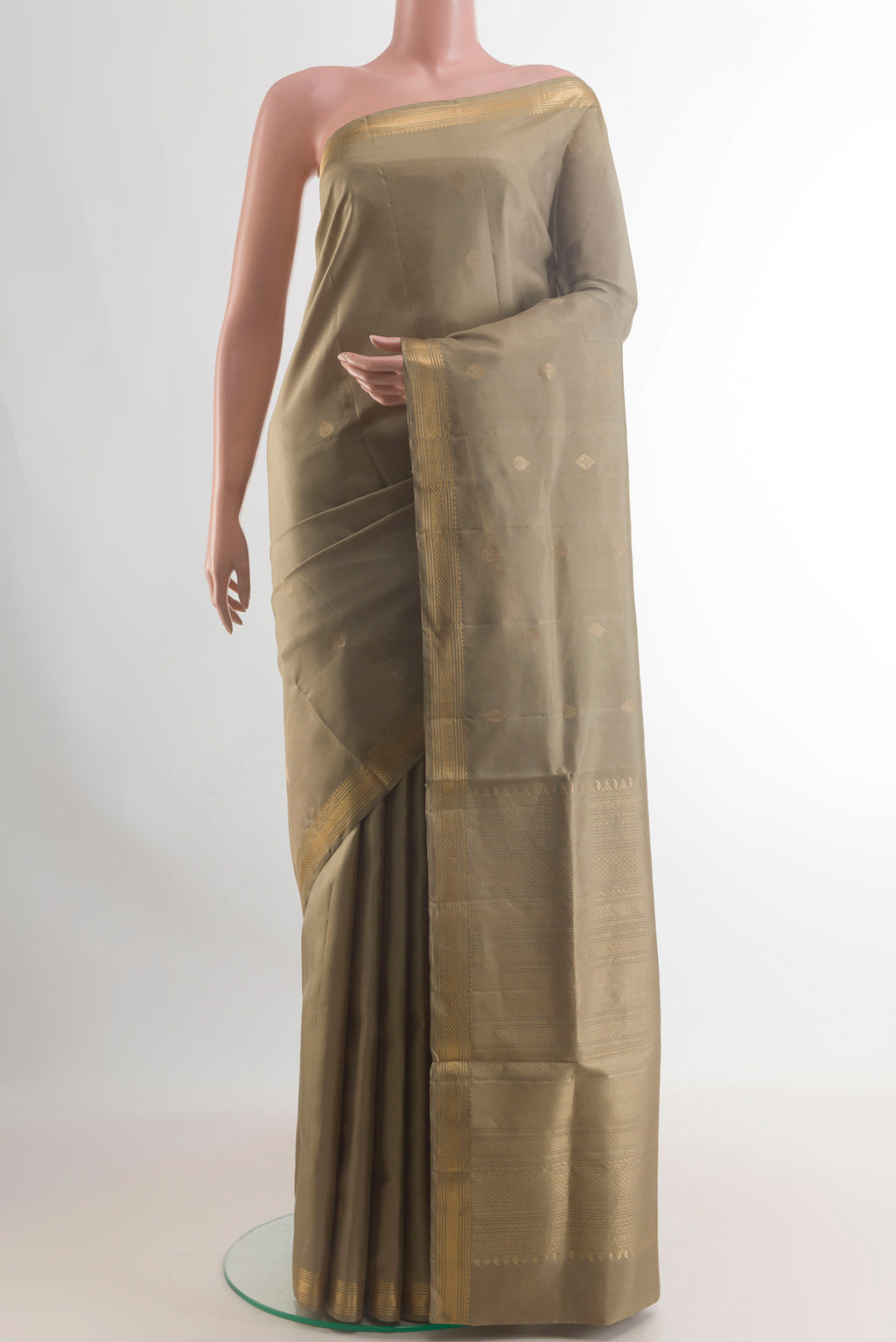 Pure Silk Dark Beige Soft Saree with Zari Butta on the body and Zari Border.  displayed on a mannequin