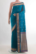 Pure Silk Peacock Blue Paithani Saree with Zari Butta on the body and Zari Border.  displayed on a mannequin