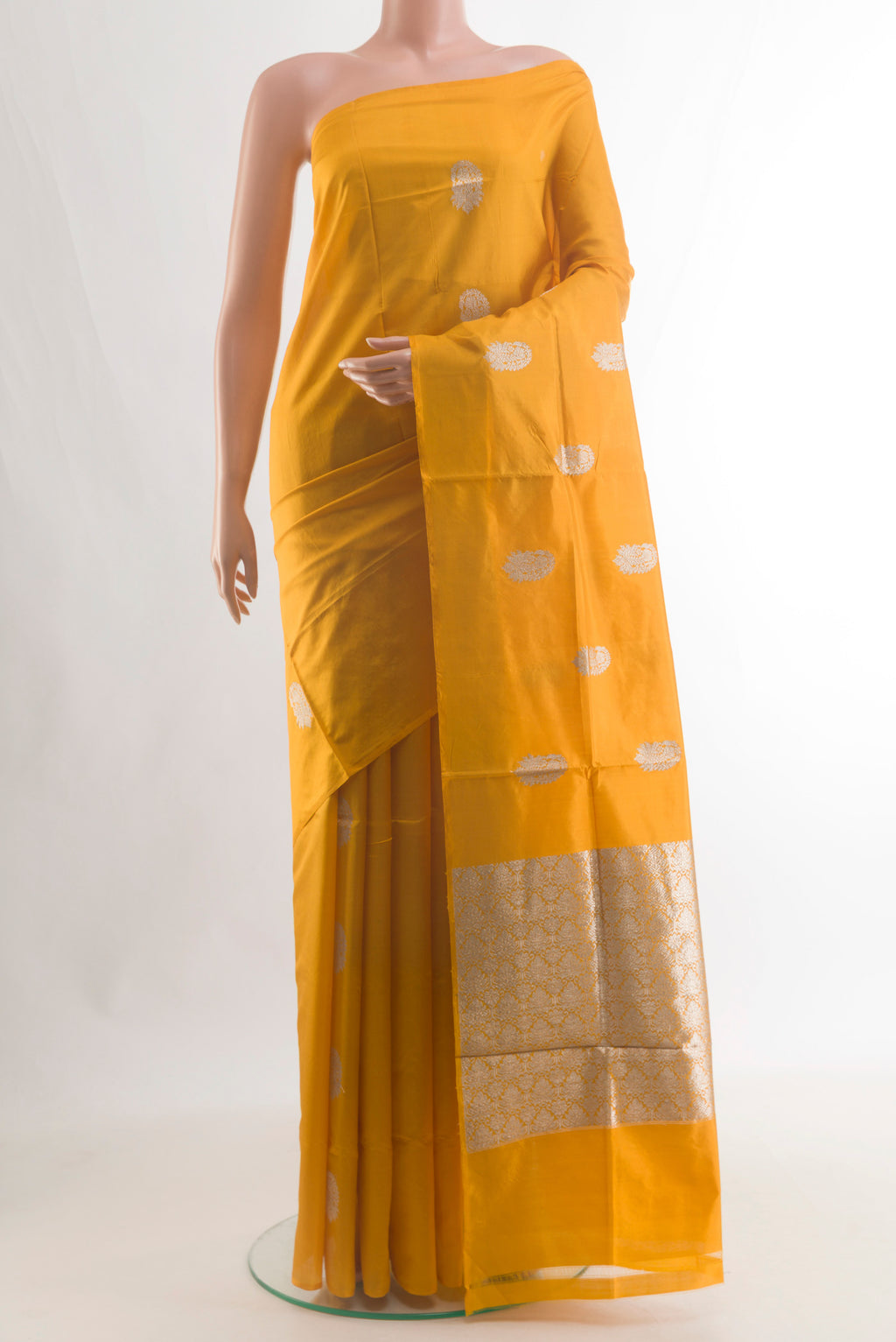 Pure Silk Yellow Banarasi Katan Saree with Zari Butta on the body and Without Border.  displayed on a mannequin