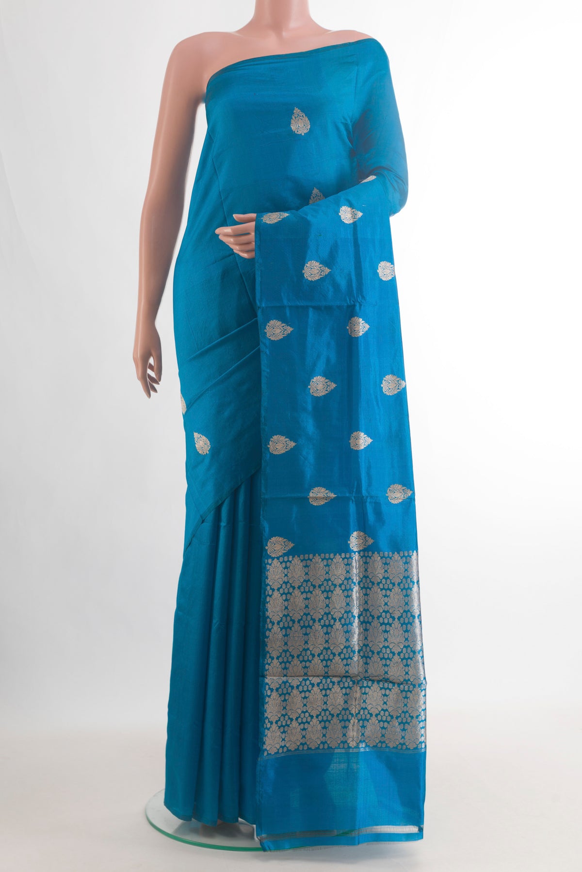 Pure Silk Blue Banarasi Katan Saree with Zari Butta on the body and Without Border.  displayed on a mannequin