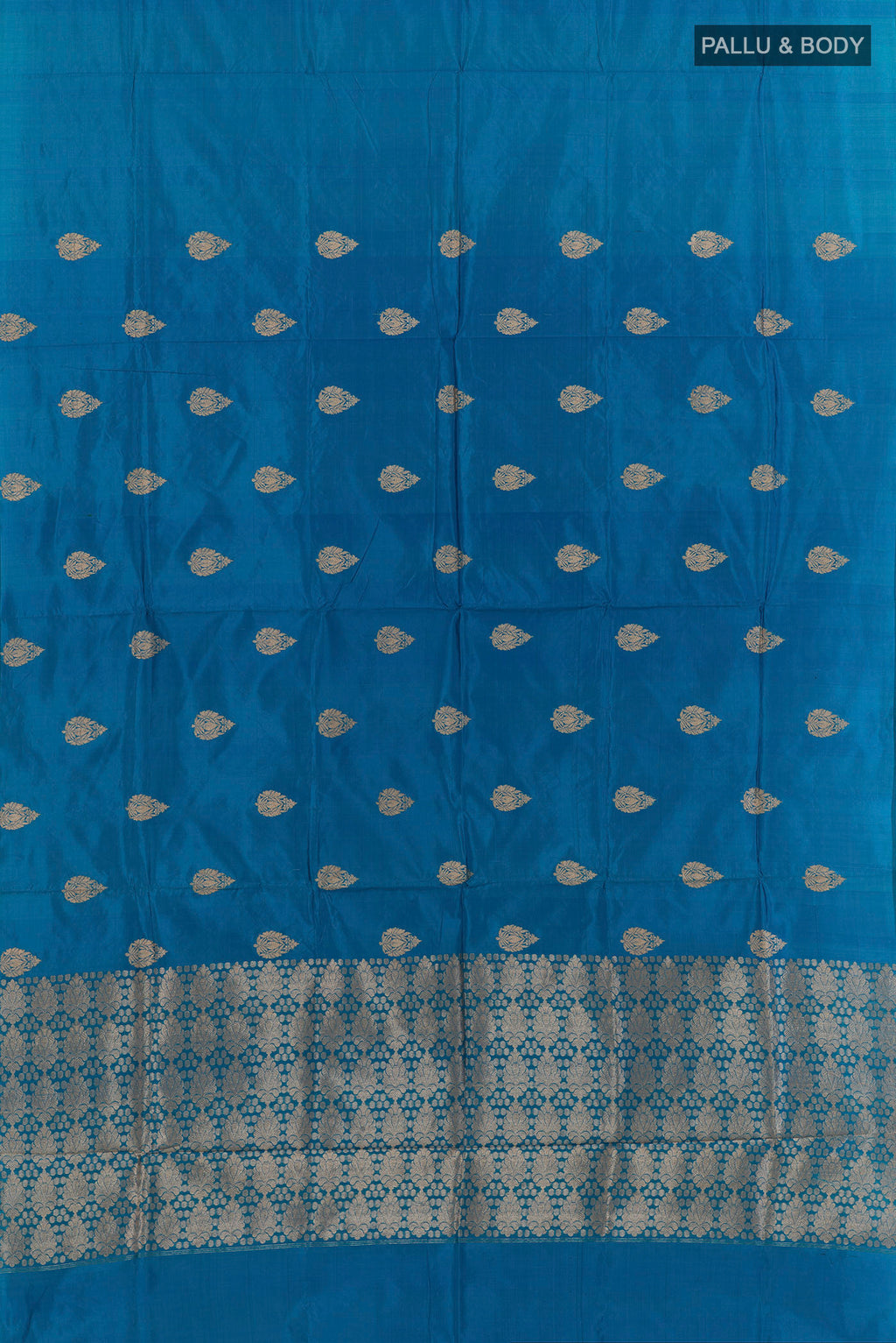 Flat view of Pure Silk Blue Banarasi Katan Saree with Zari Butta on the body and Without Border. 