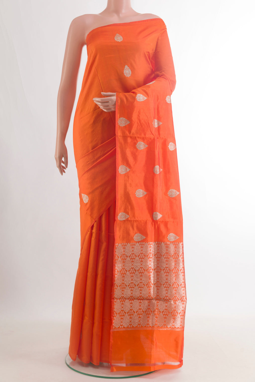 Pure Silk Orange Banarasi Katan Saree with Zari Butta on the body and Without Border.  displayed on a mannequin