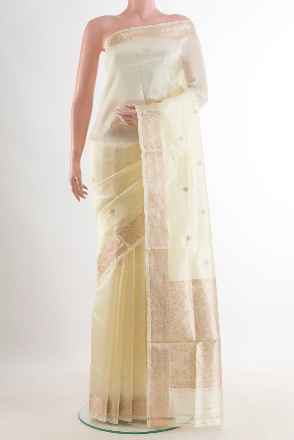 Pure Silk Off White Banarasi Katan Saree with Zari Butta on the body and Zari Border.  displayed on a mannequin