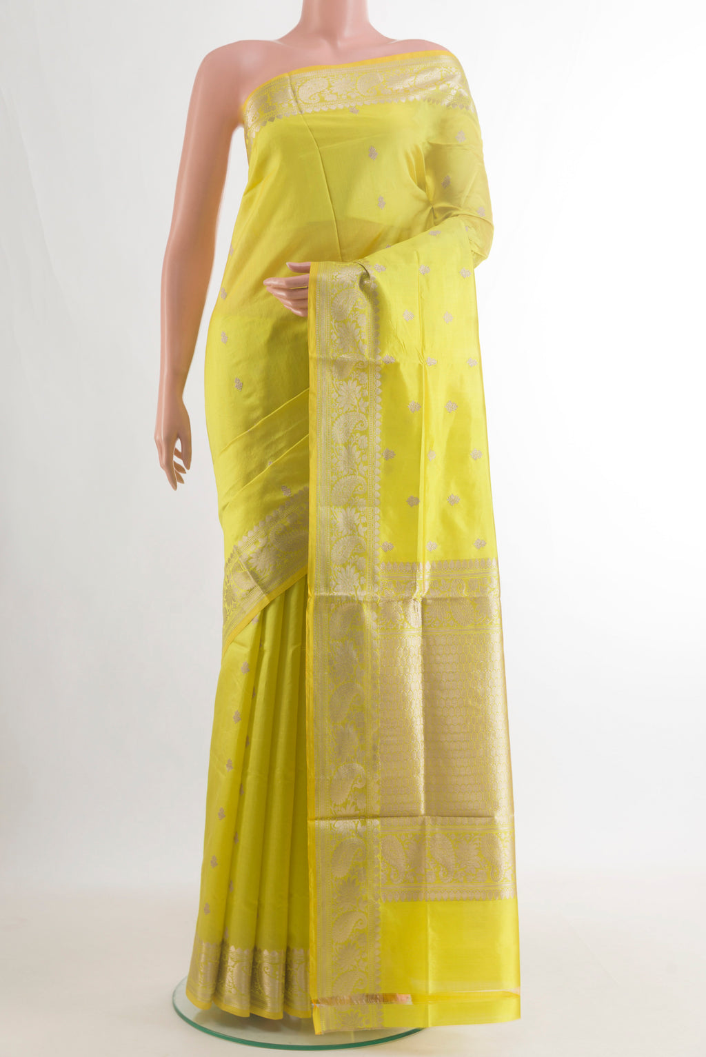 Pure Silk Lemon Yellow Banarasi Katan Saree with Zari Butta on the body and Zari Border.  displayed on a mannequin