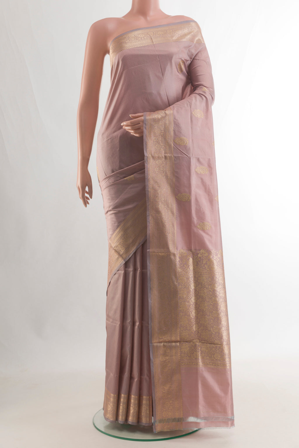Pure Silk Rose Gold Banarasi Katan Saree with Zari Butta on the body and Zari Border.  displayed on a mannequin