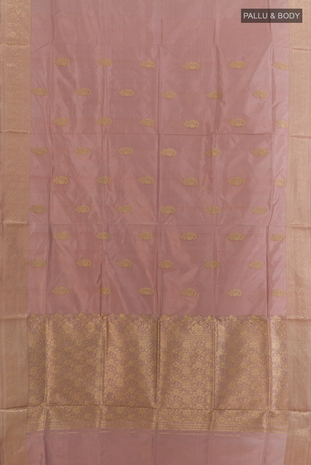 Flat view of Pure Silk Rose Gold Banarasi Katan Saree with Zari Butta on the body and Zari Border. 