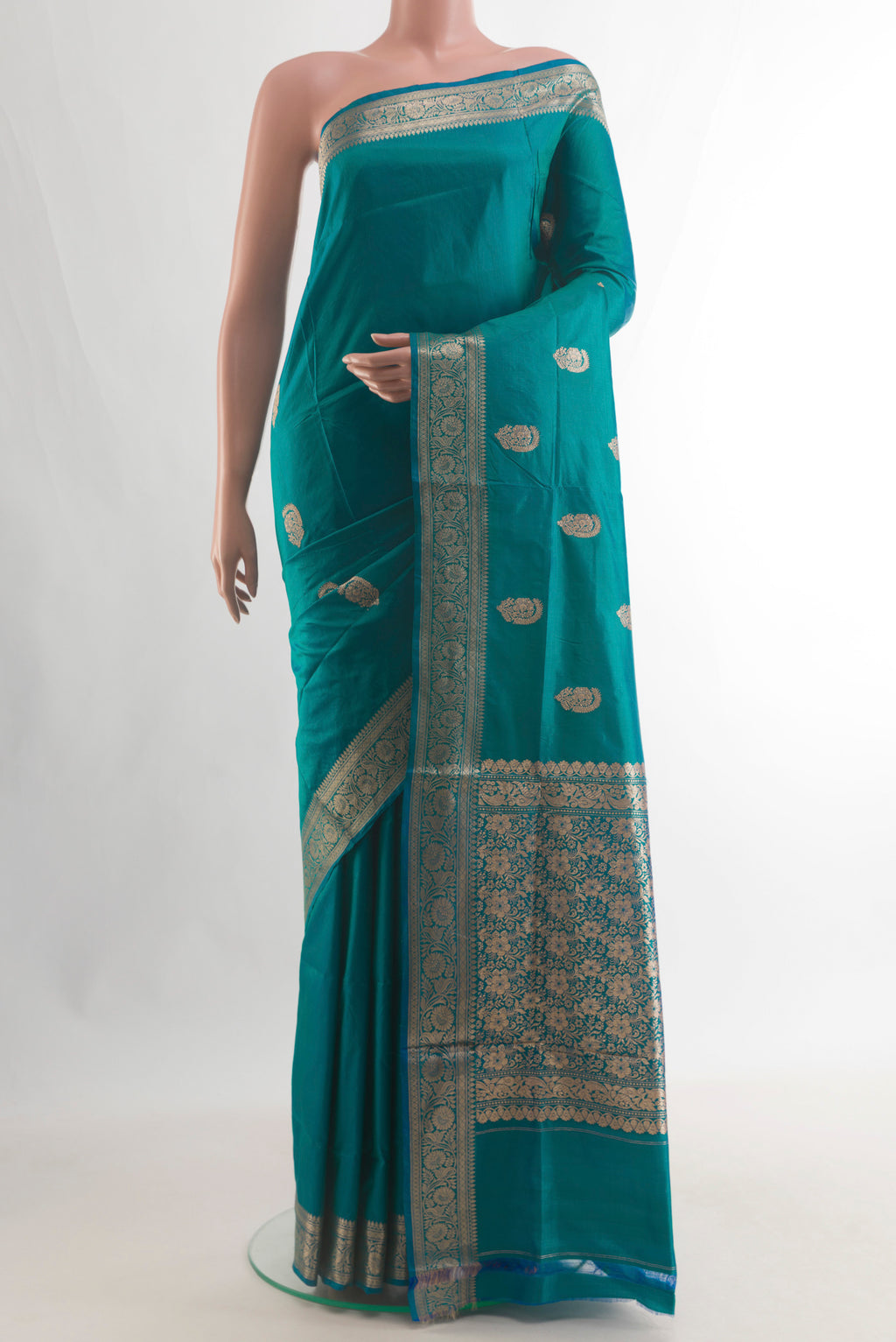 Pure Silk Peacock Blue Dual Tone Banarasi Katan Saree with Zari Butta on the body and Zari Border.  displayed on a mannequin