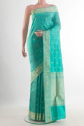 Pure Silk Sea Green Banarasi Katan Saree with Thread Butta on the body and Thread Border.  displayed on a mannequin