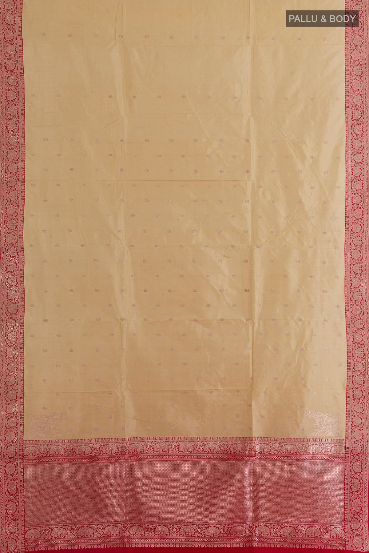 Flat view of Pure Silk Cream Banarasi Katan Saree with Zari Butta on the body and Zari Border. 