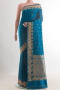 Pure Silk Blue Banarasi Katan Saree with Zari Butta on the body and Zari Border.  displayed on a mannequin