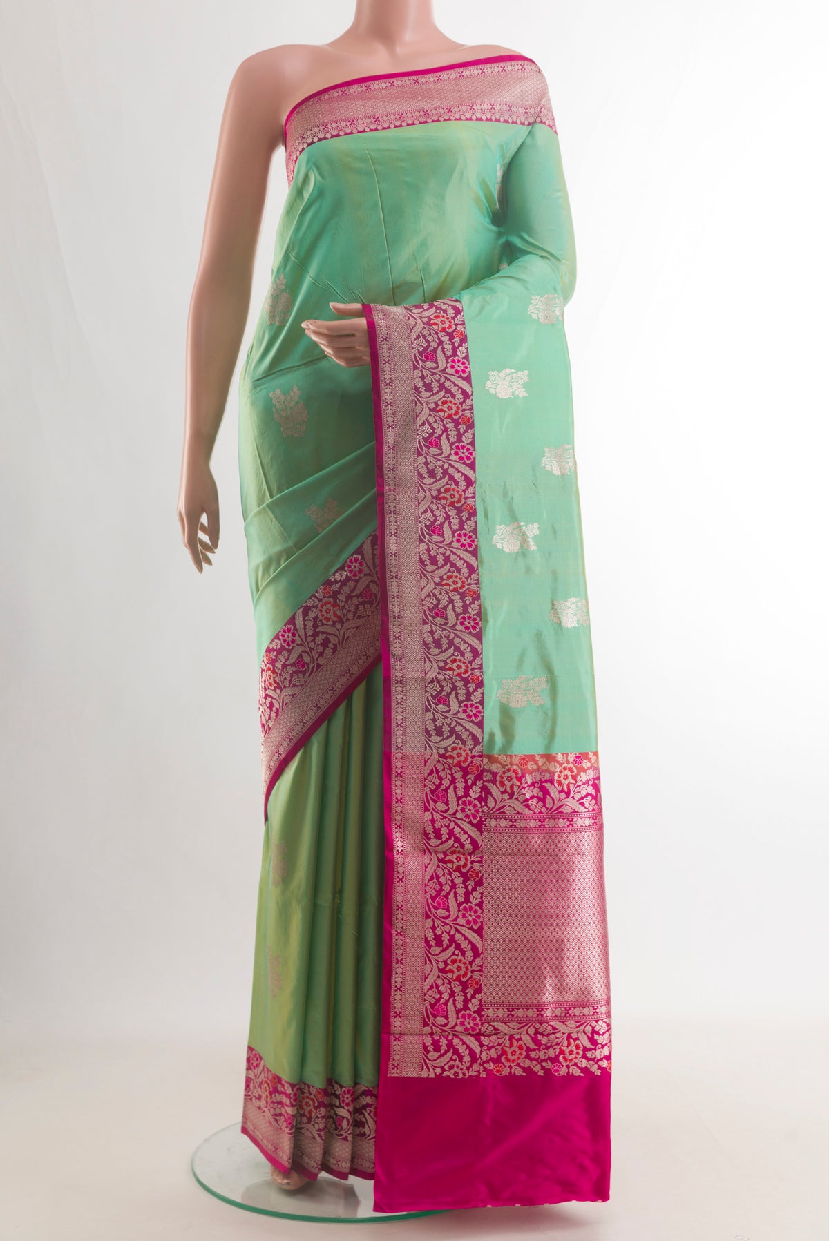 Pure Silk Green Banarasi Katan Saree with Zari Butta on the body and Zari Border.  displayed on a mannequin