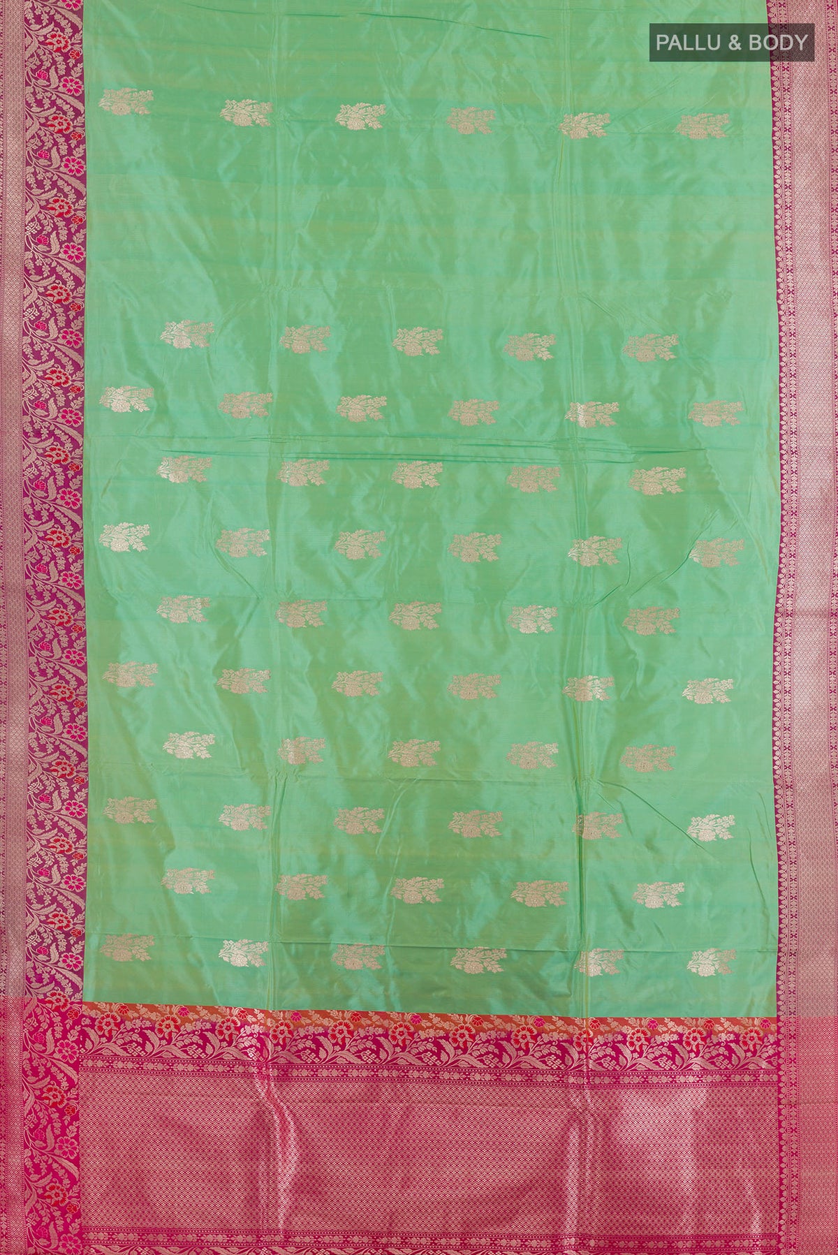 Flat view of Pure Silk Green Banarasi Katan Saree with Zari Butta on the body and Zari Border. 