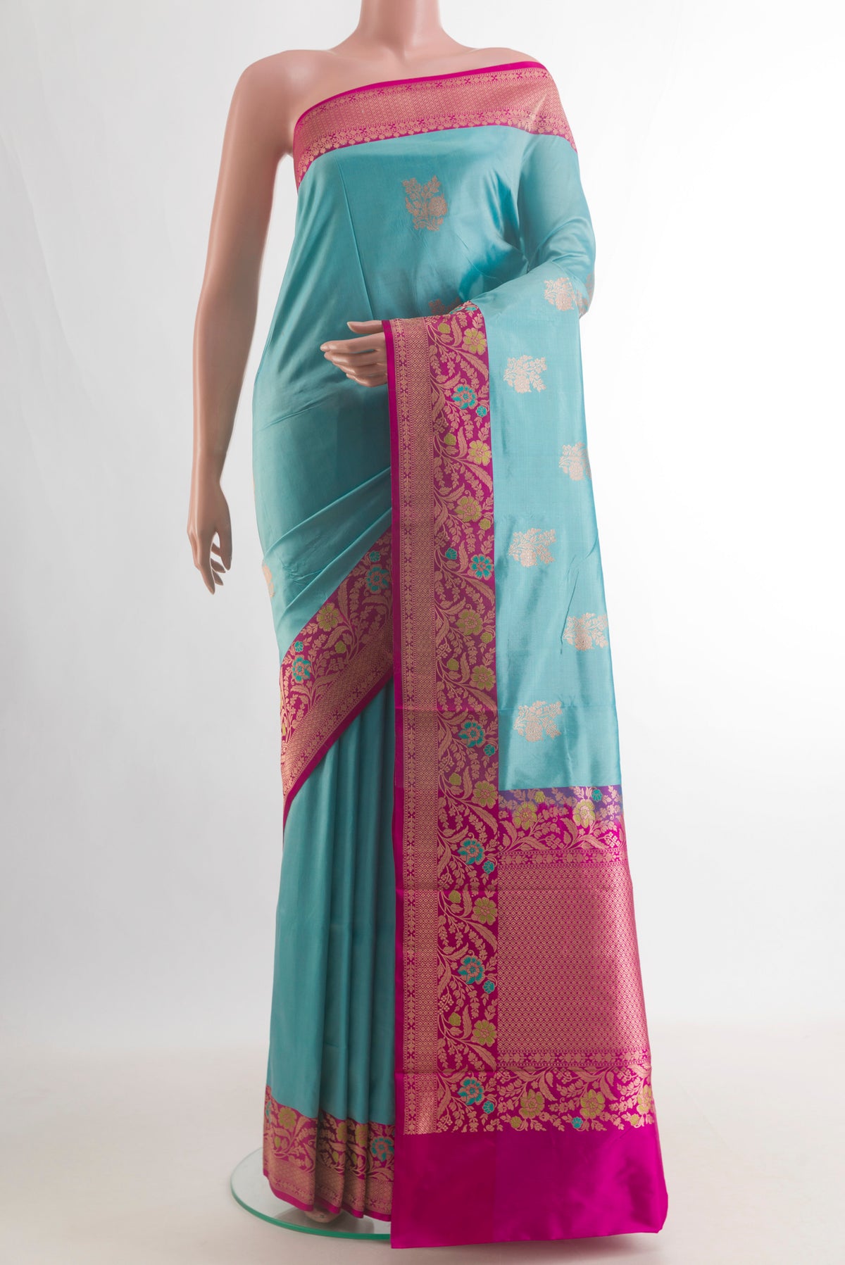 Pure Silk Blue Banarasi Katan Saree with Zari Butta on the body and Zari Border.  displayed on a mannequin