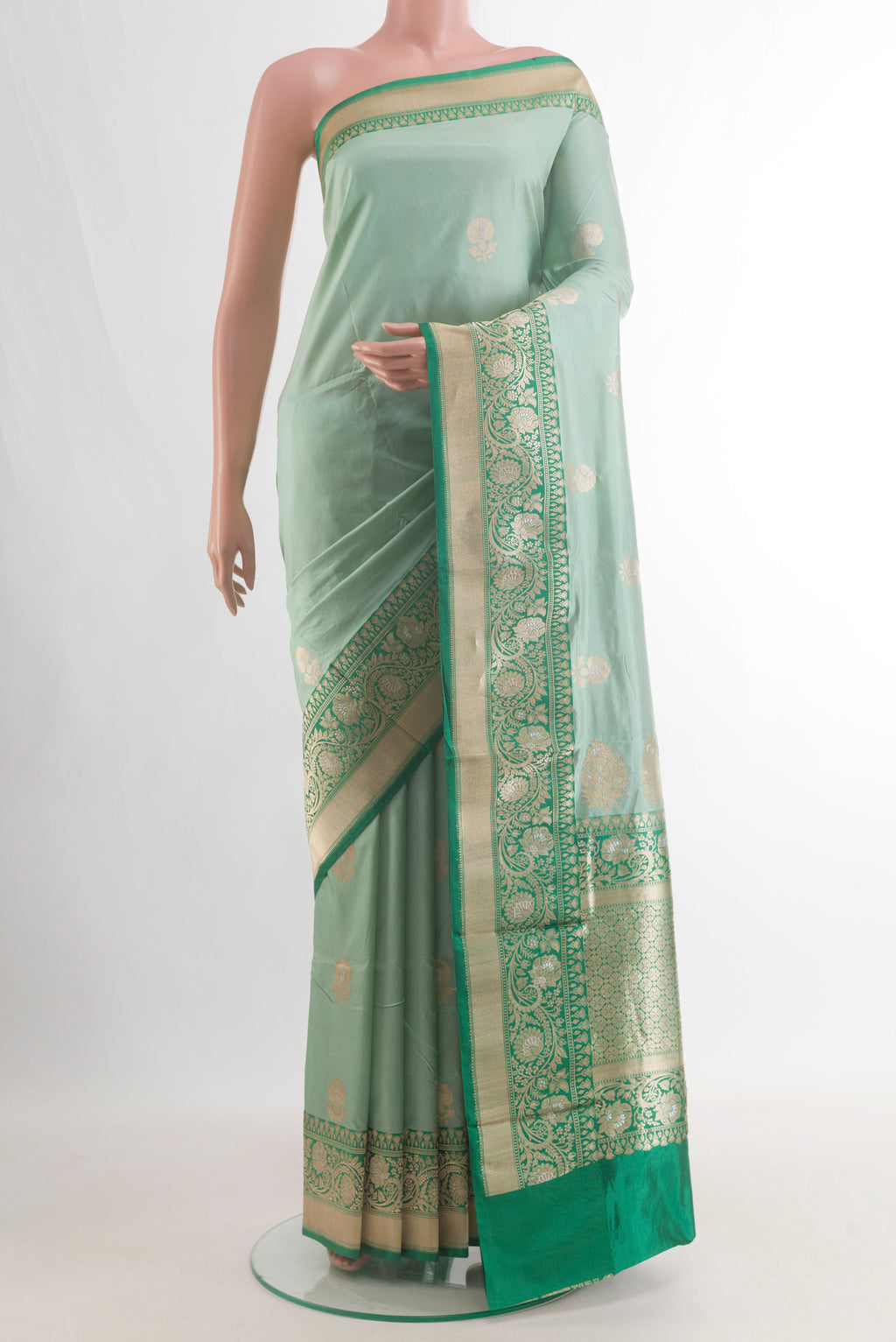 Pure Silk Mint Green Banarasi Katan Saree with Zari Butta on the body and Zari Border.  displayed on a mannequin