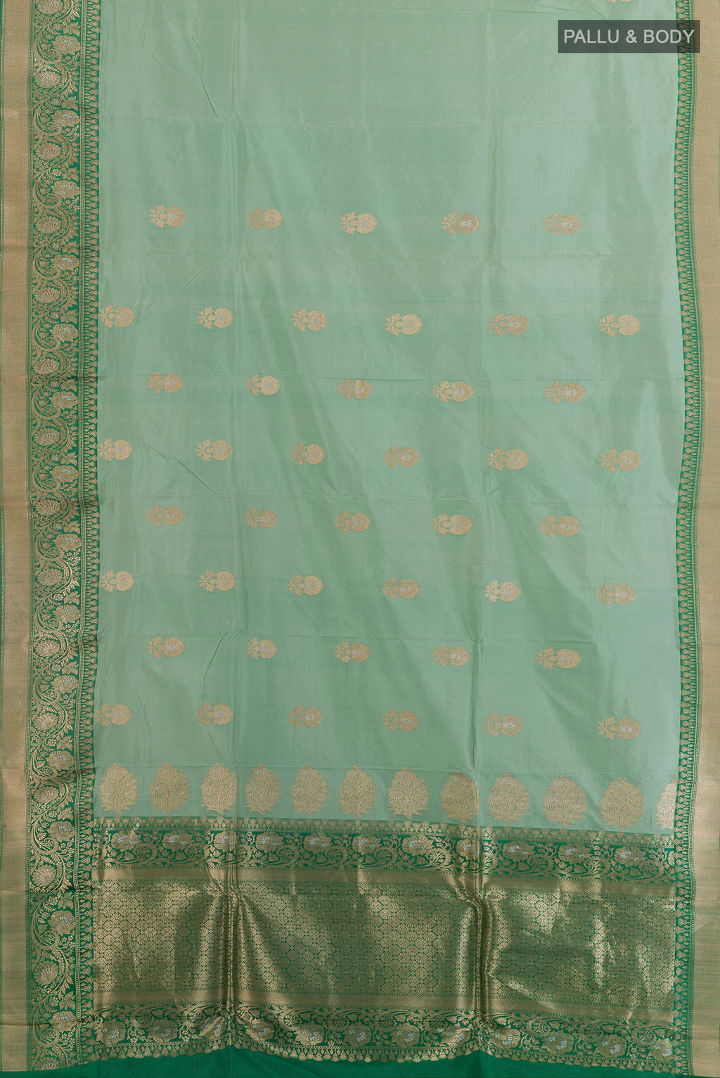 Flat view of Pure Silk Mint Green Banarasi Katan Saree with Zari Butta on the body and Zari Border. 