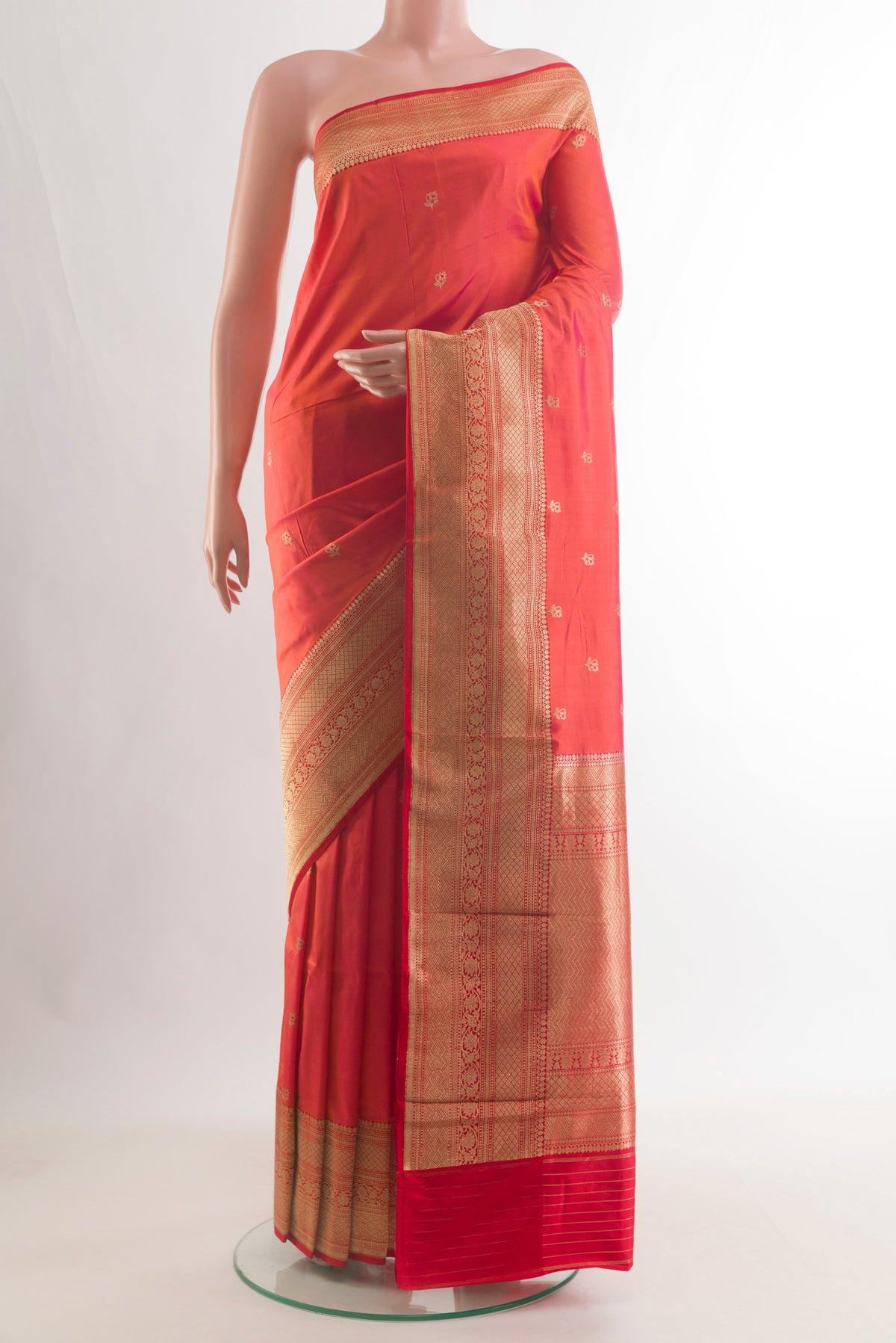 Pure Silk Orange Banarasi Katan Saree with Zari Butta on the body and Zari Border.  displayed on a mannequin