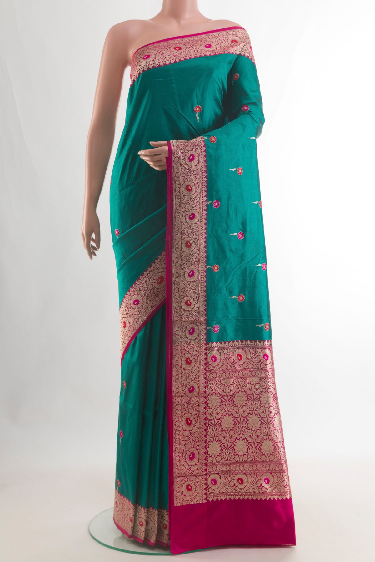 Pure Silk Green Banarasi Katan Saree with Zari And Thread Butta on the body and Zari Border.  displayed on a mannequin