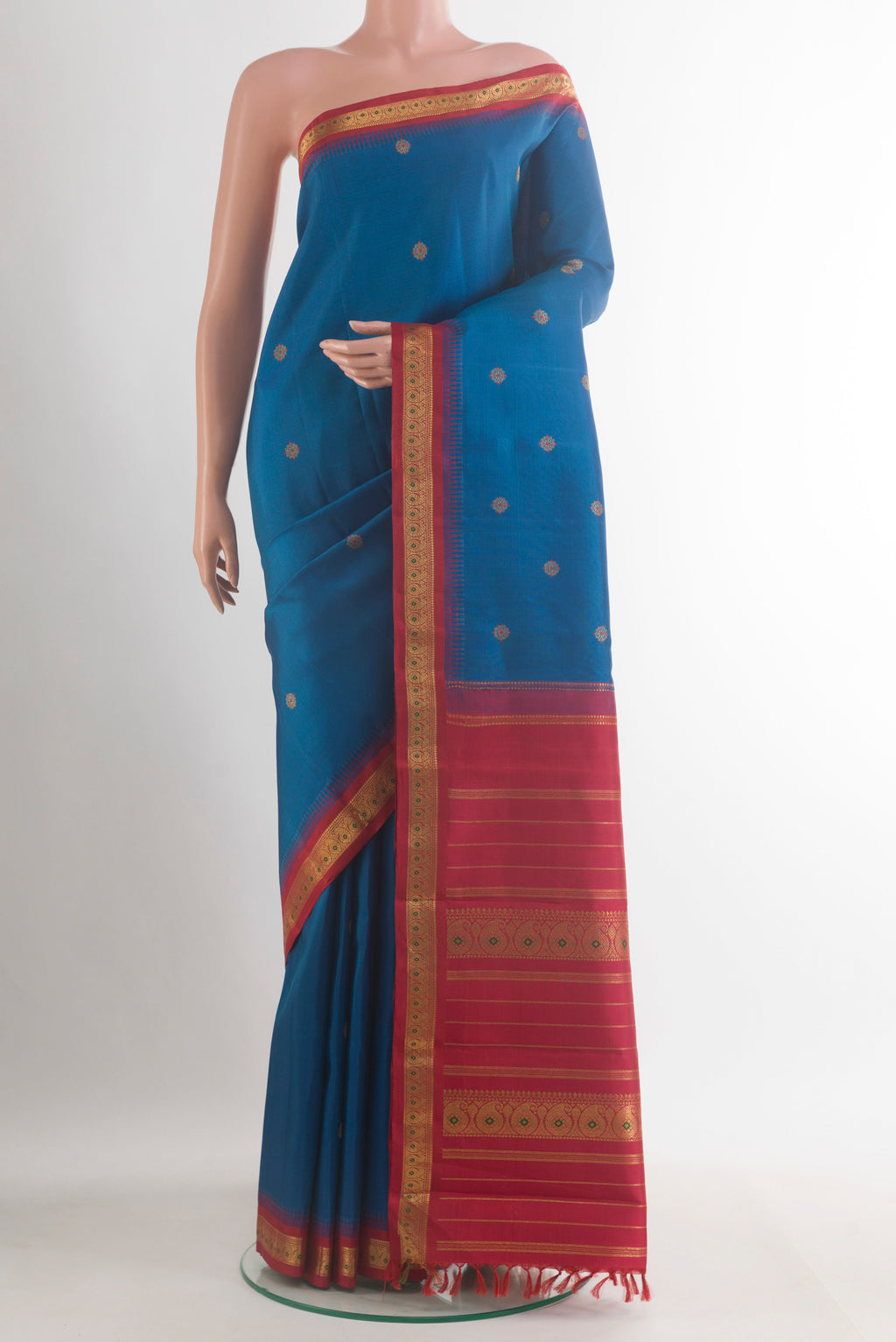 Pure Silk Pure Zari Blue Kanjivaram Saree with Zari Butta on the body and Zari Border.  displayed on a mannequin