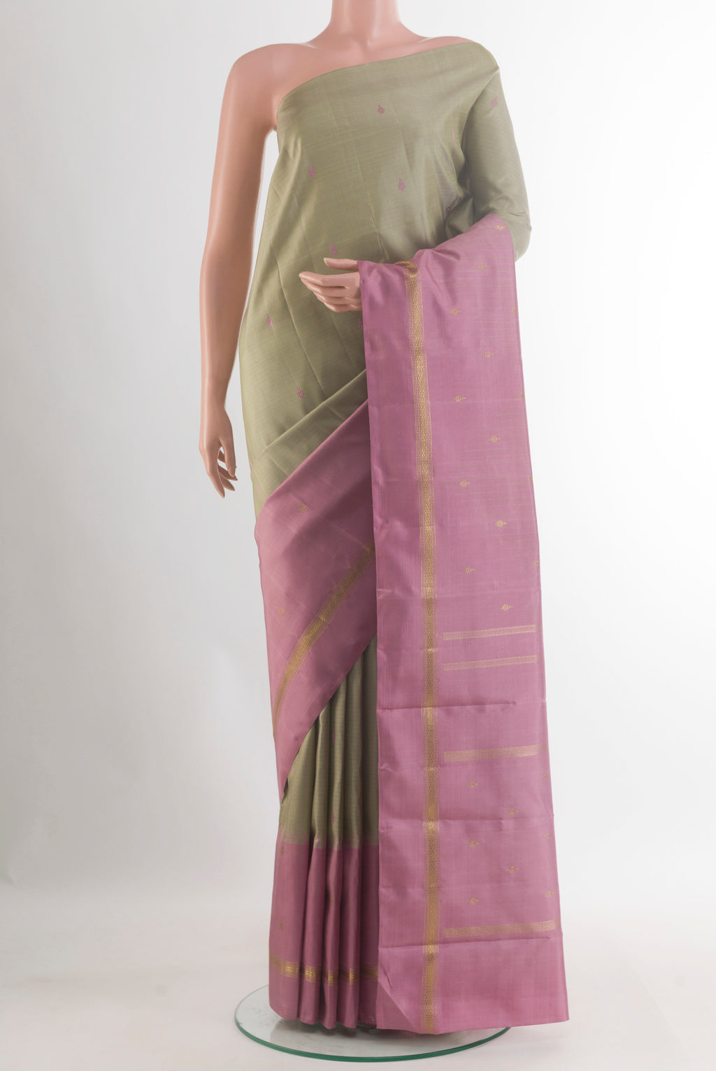 Pure Silk Green Kanchipuram Saree with Checked design on the body and Zari Border.  displayed on a mannequin