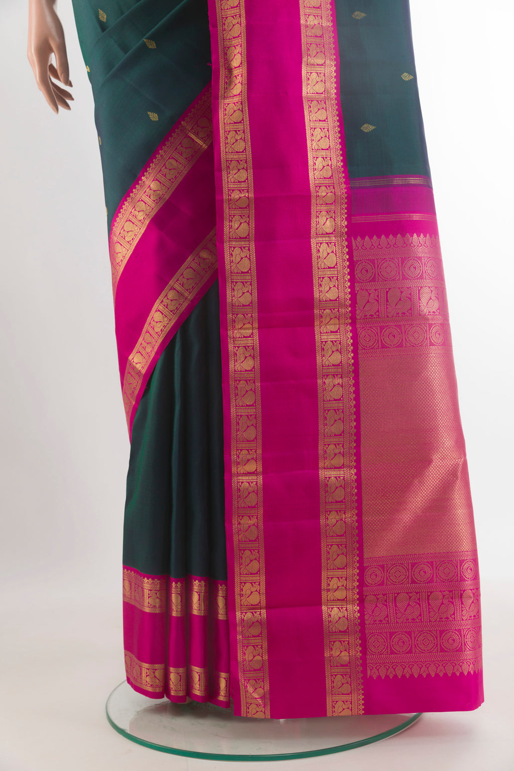 Pleats and pallu of Pure Silk Pure Zari Green Kanjivaram Saree with Zari Butta on the body and Zari Border. 