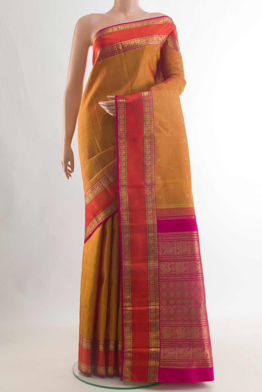 Pure Silk Pure Zari Mustard Kanjivaram Saree with Zari Butta on the body and Zari Border.  displayed on a mannequin