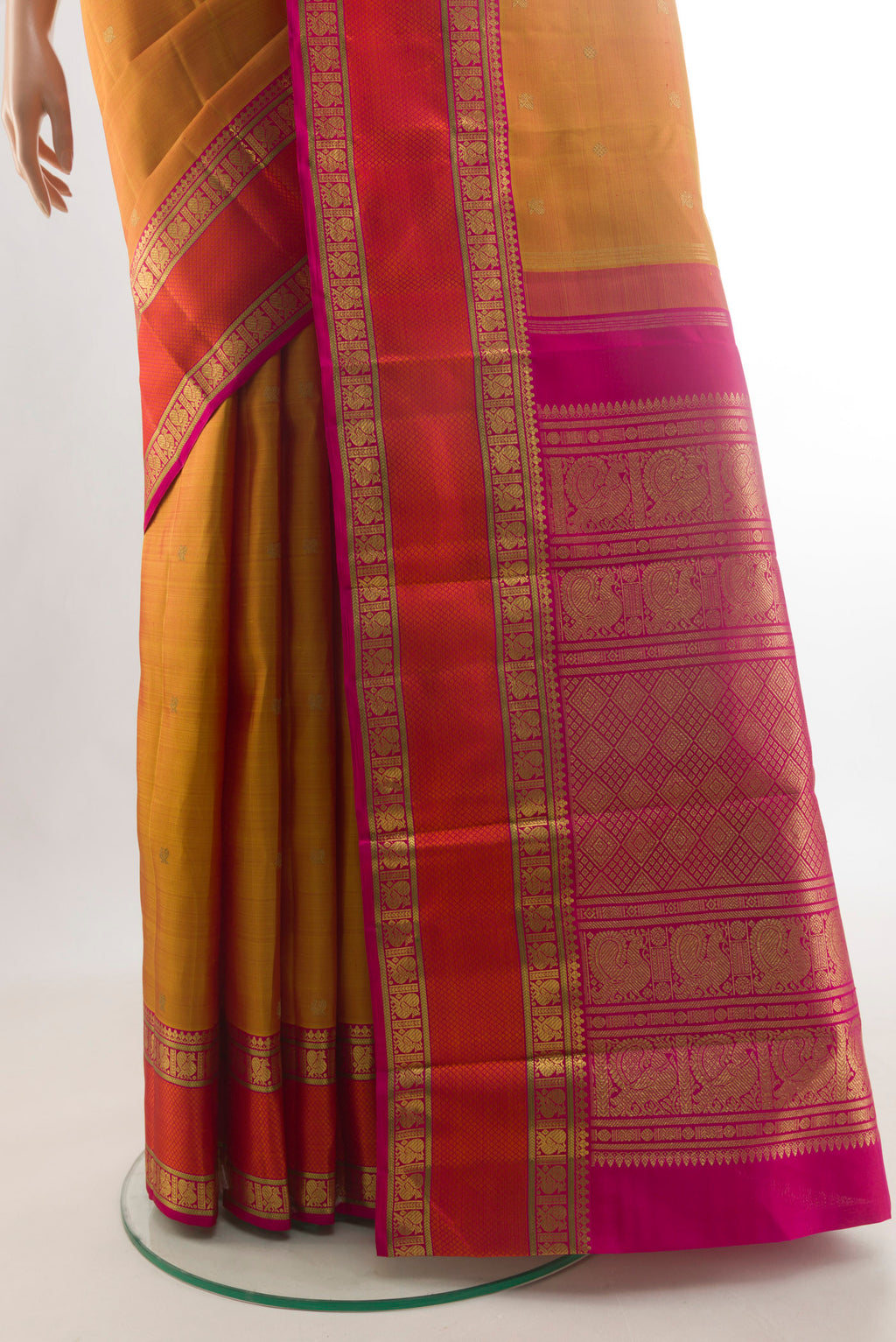 Pleats and pallu of Pure Silk Pure Zari Mustard Kanjivaram Saree with Zari Butta on the body and Zari Border. 