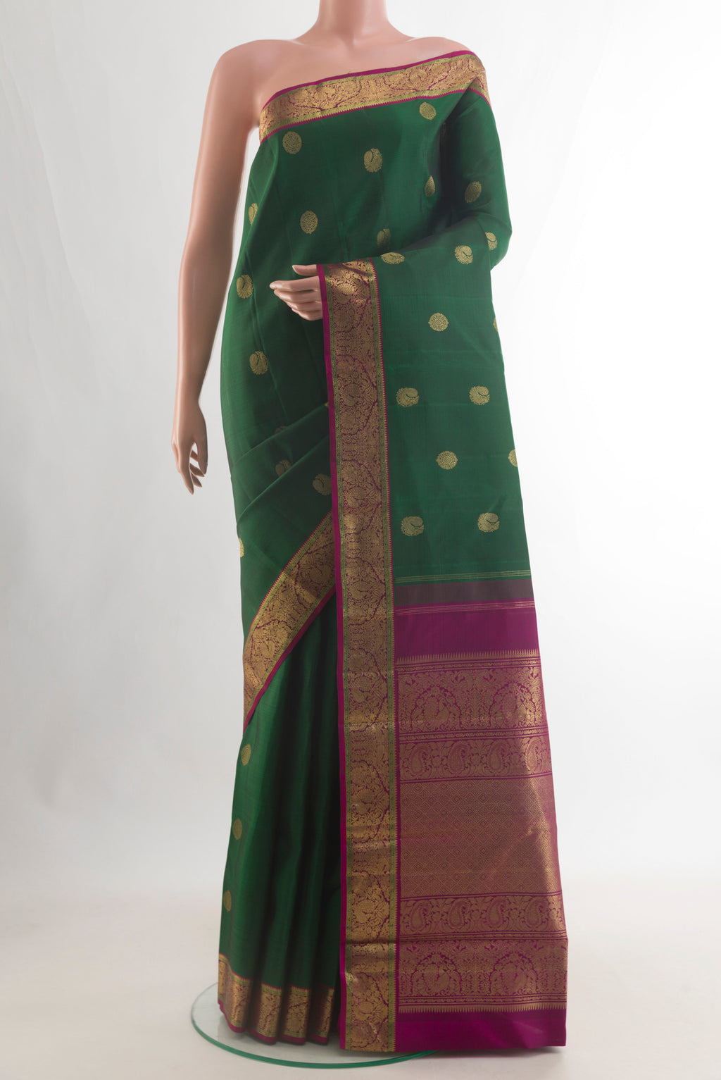 Pure Silk Pure Zari Bottle Green Kanjivaram Saree with Zari Butta on the body and Zari Border.  displayed on a mannequin