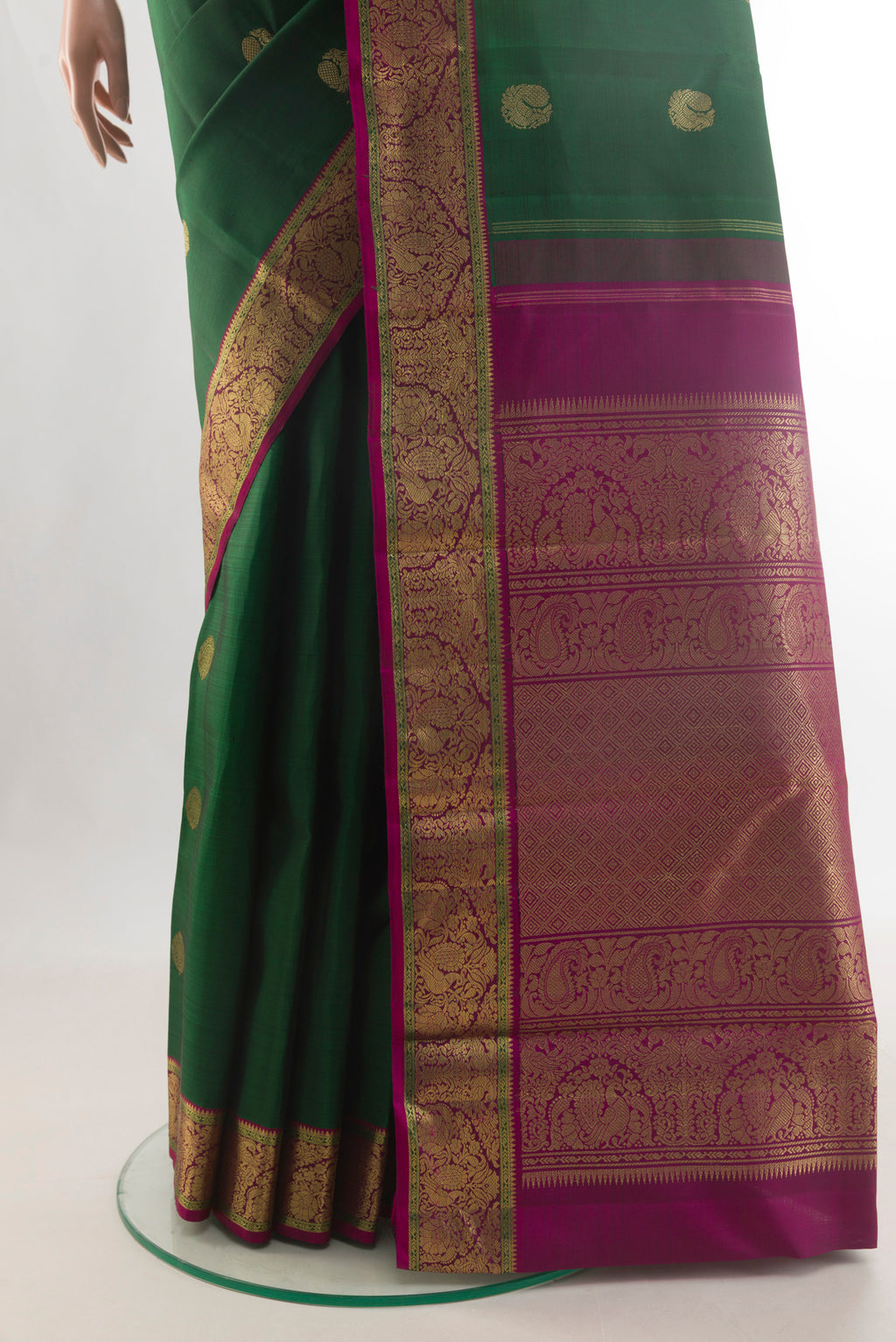 Pleats and pallu of Pure Silk Pure Zari Bottle Green Kanjivaram Saree with Zari Butta on the body and Zari Border. 