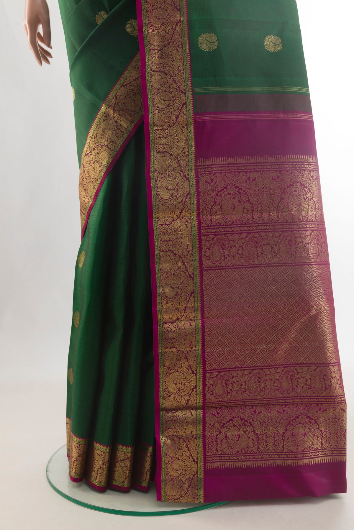 Pleats and pallu of Pure Silk Pure Zari Bottle Green Kanjivaram Saree with Zari Butta on the body and Zari Border. 