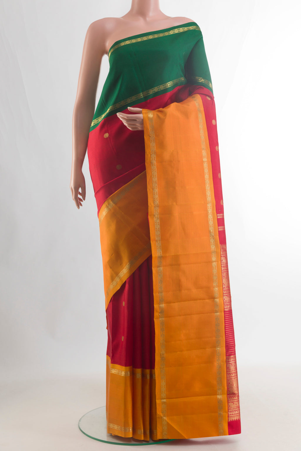 Pure Silk Pure Zari Red Kanjivaram Saree with Zari Butta on the body and Ganga Jamuna Border.  displayed on a mannequin