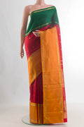 Pure Silk Pure Zari Red Kanjivaram Saree with Zari Butta on the body and Ganga Jamuna Border.  displayed on a mannequin