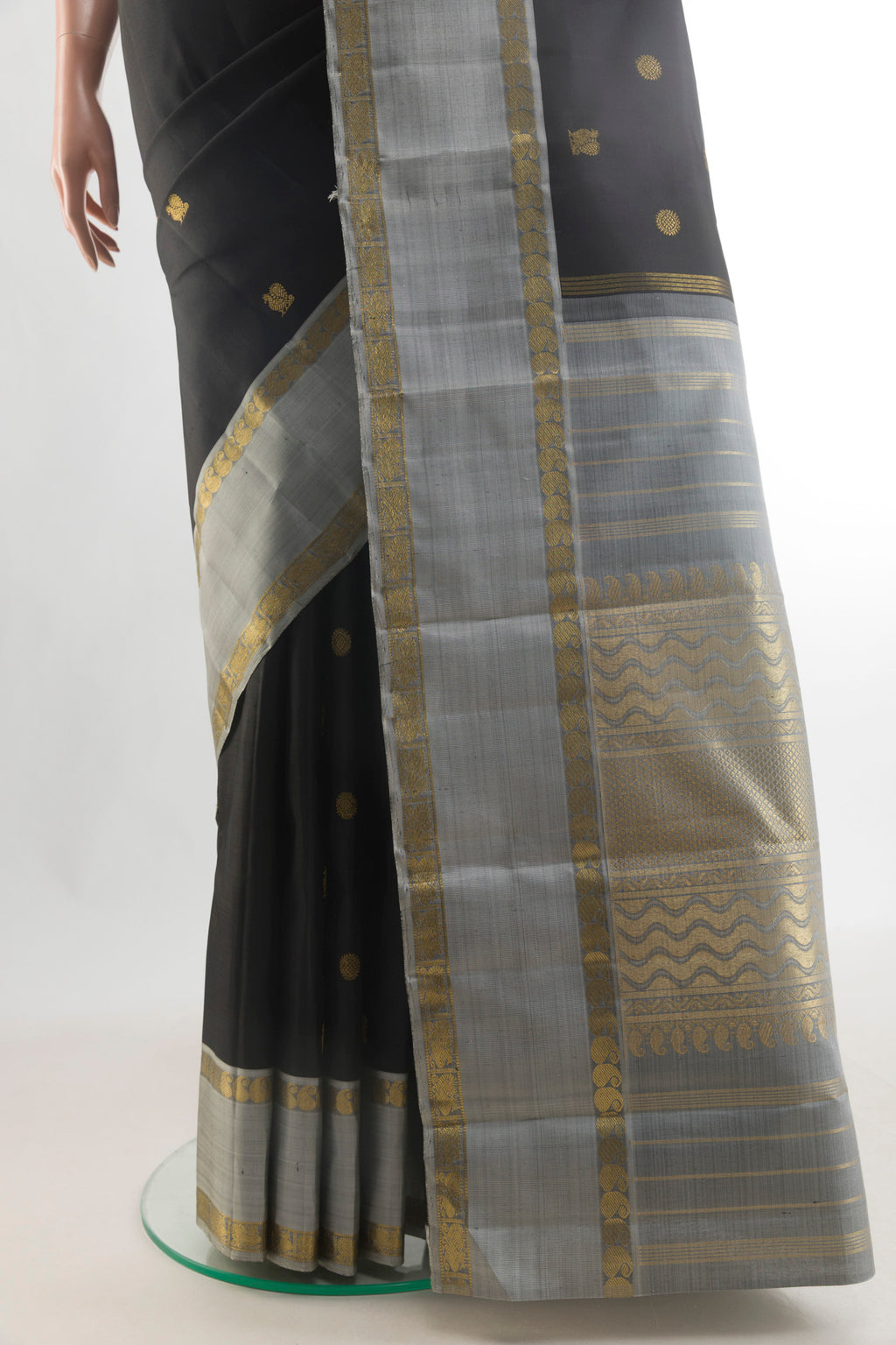 Pleats and pallu of Pure Silk Pure Zari Black Kanchipuram Saree with Zari Butta on the body and Zari Border. 