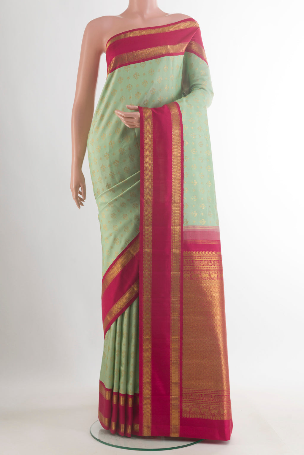 Pure Silk Pure Zari Mint Green Kanjivaram Saree with Zari Butta on the body and Zari Border.  displayed on a mannequin
