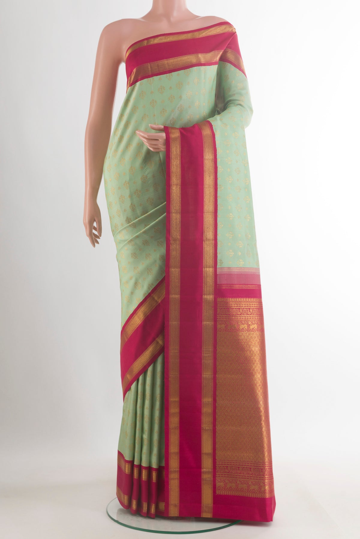 Pure Silk Pure Zari Mint Green Kanjivaram Saree with Zari Butta on the body and Zari Border.  displayed on a mannequin