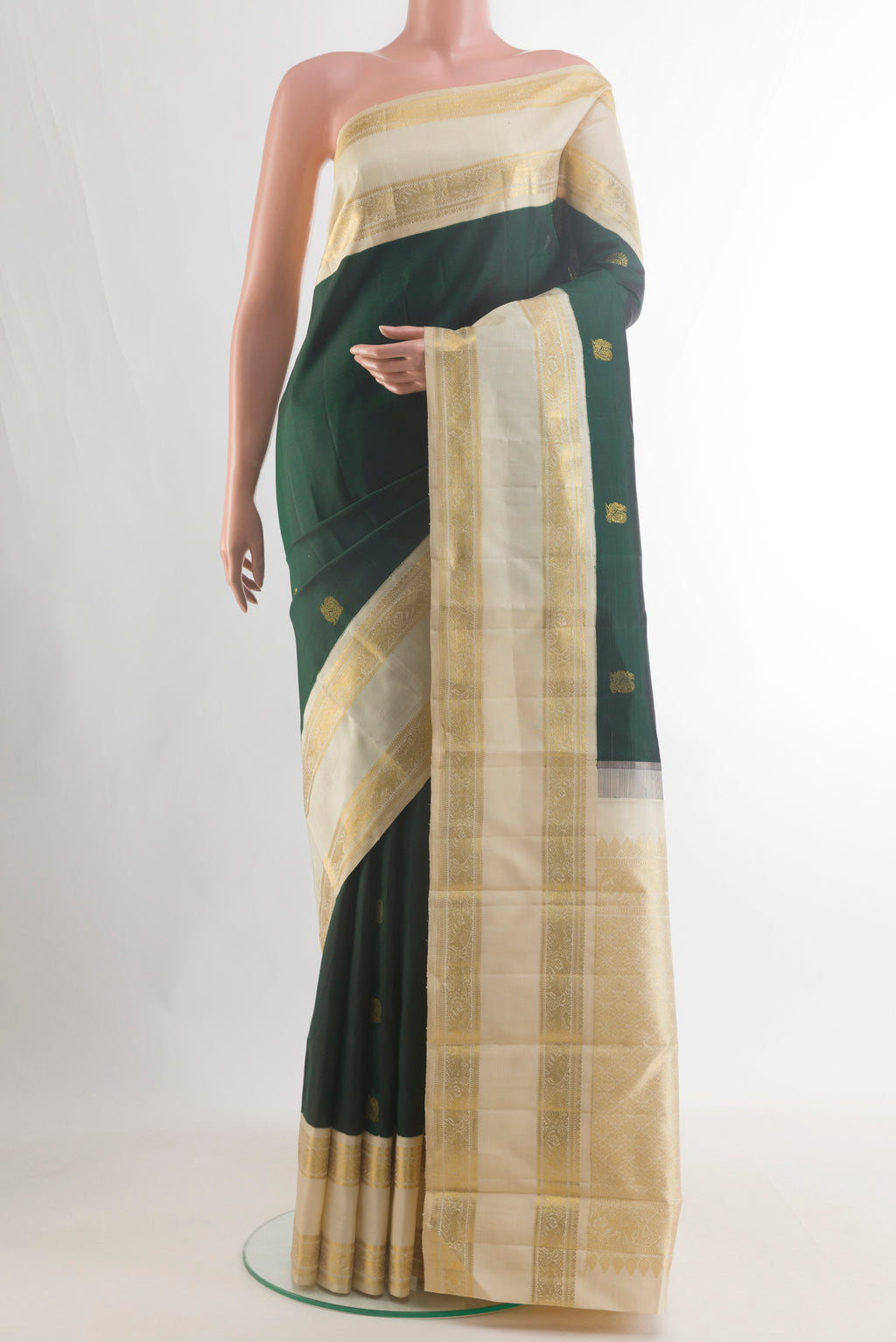 Pure Silk Pure Zari Bottle Green Kanjivaram Saree with Zari Butta on the body and Zari Border.  displayed on a mannequin