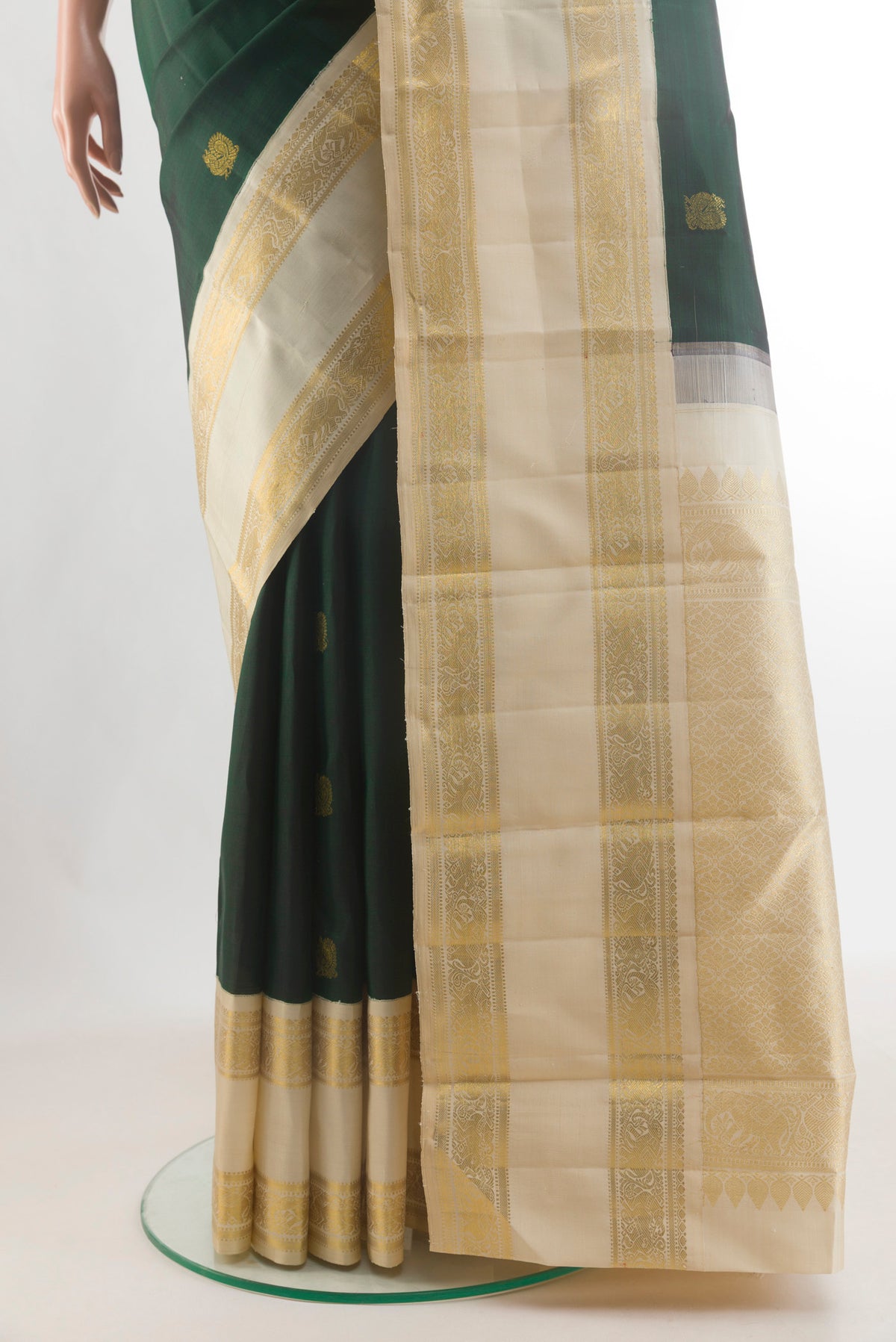 Pleats and pallu of Pure Silk Pure Zari Bottle Green Kanjivaram Saree with Zari Butta on the body and Zari Border. 