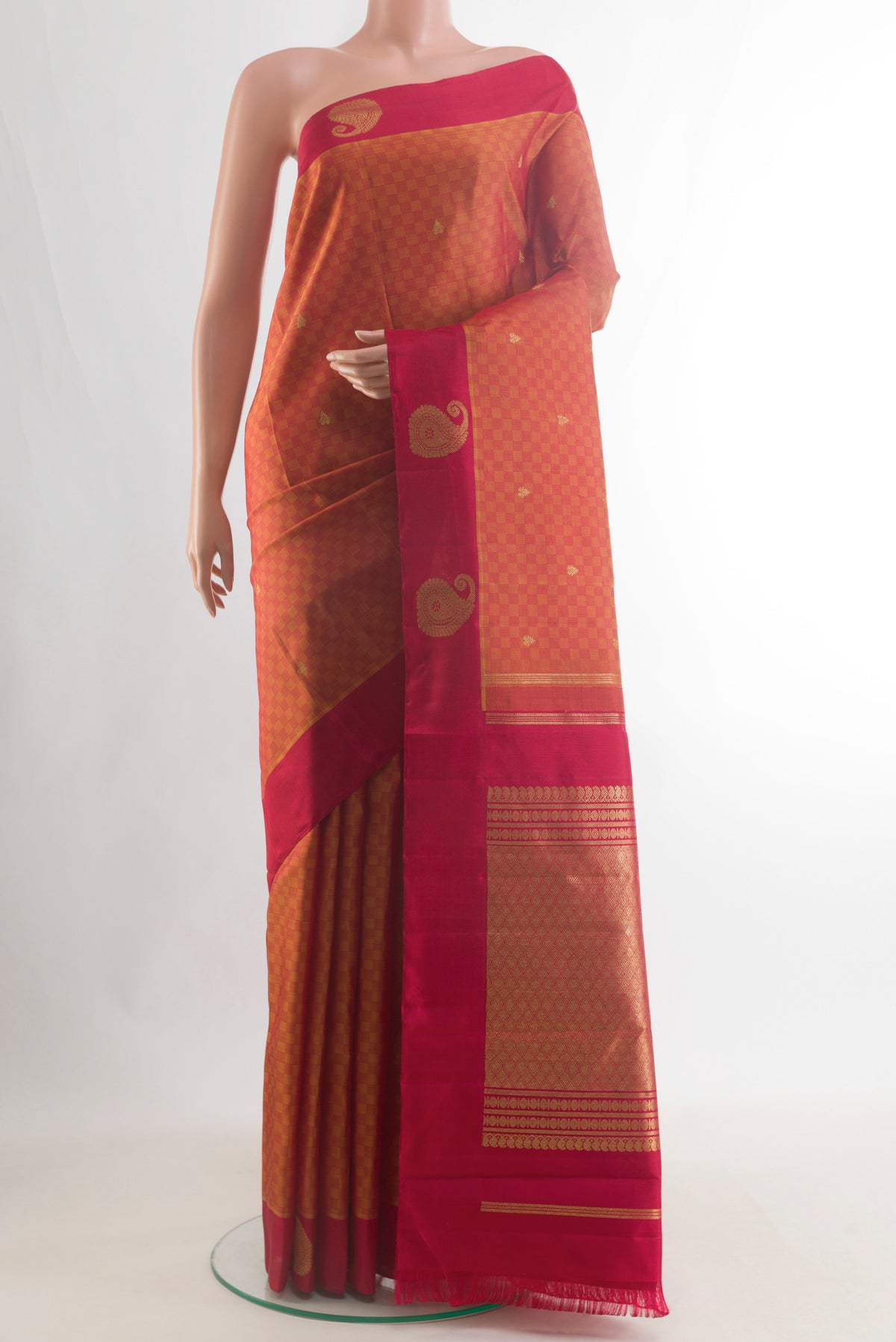 Pure Silk Pure Zari Rust Kanchipuram Saree with Jacquard With Zari Butta on the body and Zari Border.  displayed on a mannequin