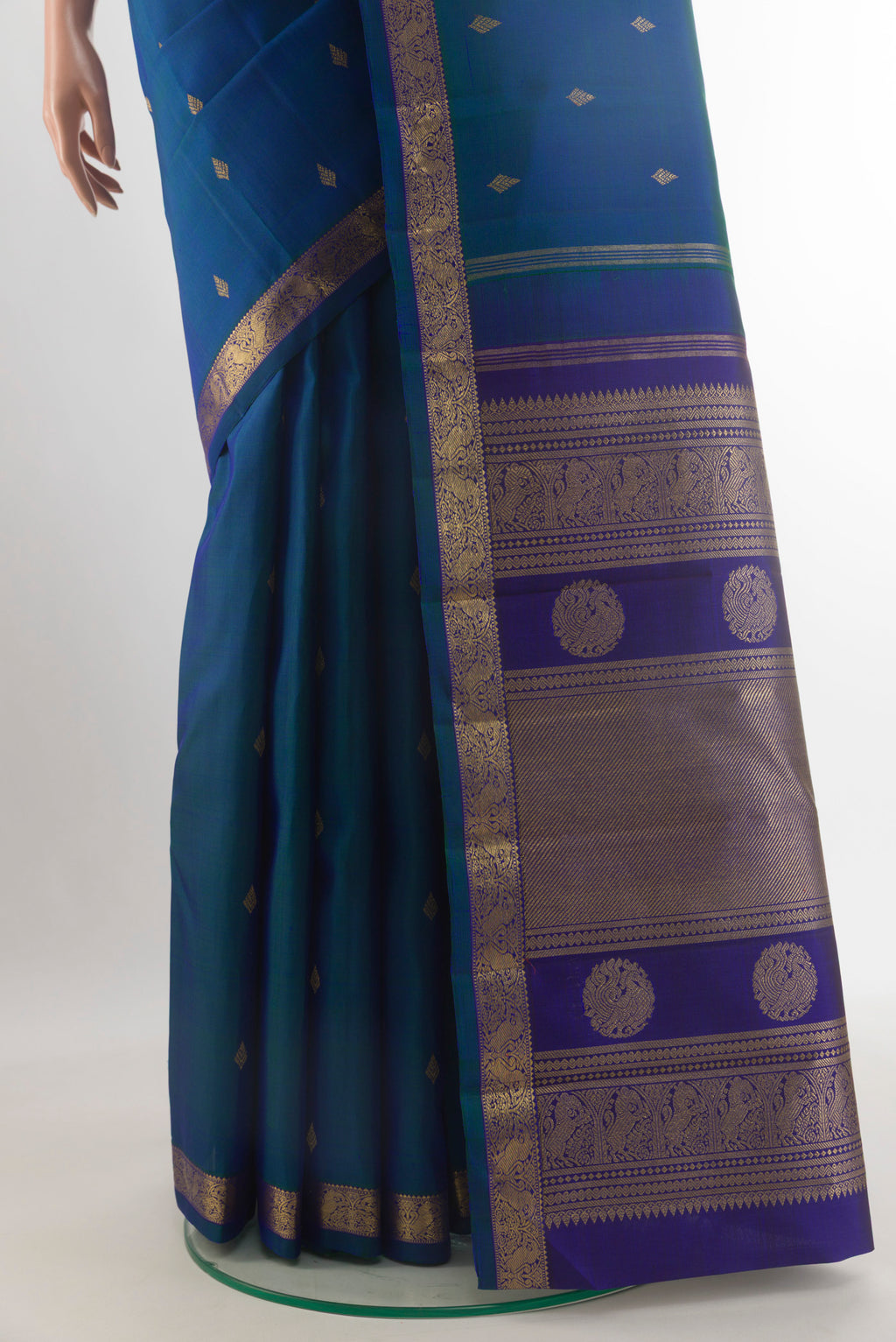 Pleats and pallu of Pure Silk Pure Zari Peacock Blue Kanchipuram Saree with Zari Butta on the body and Zari Border. 