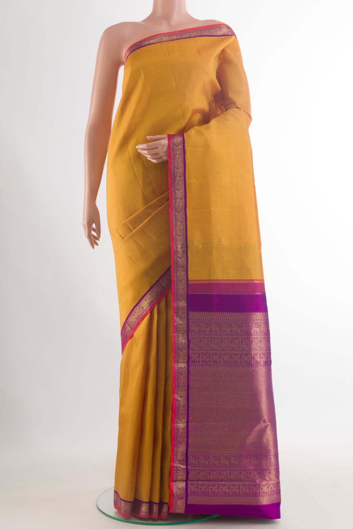 Pure Silk Pure Zari Mustard Kanjivaram Saree with Zari Butta on the body and Zari Border.  displayed on a mannequin