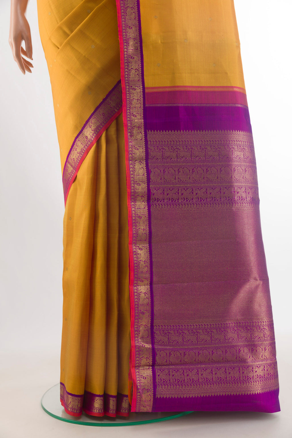 Pleats and pallu of Pure Silk Pure Zari Mustard Kanjivaram Saree with Zari Butta on the body and Zari Border. 